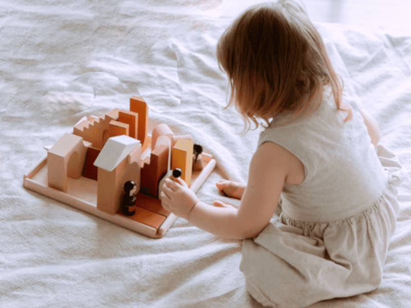 girl playing with wood blocks