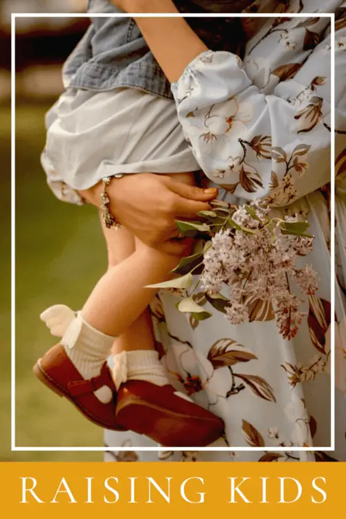 woman holding toddler dress flower "Raising Kids" 