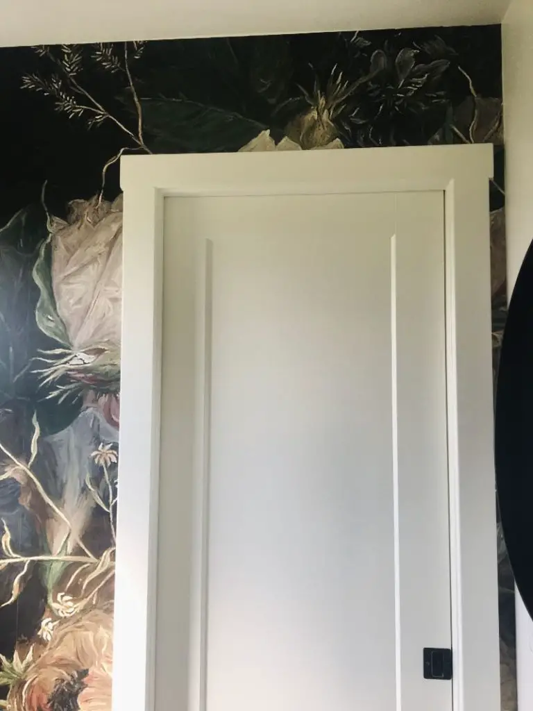 Bathroom wallpaper around door trim