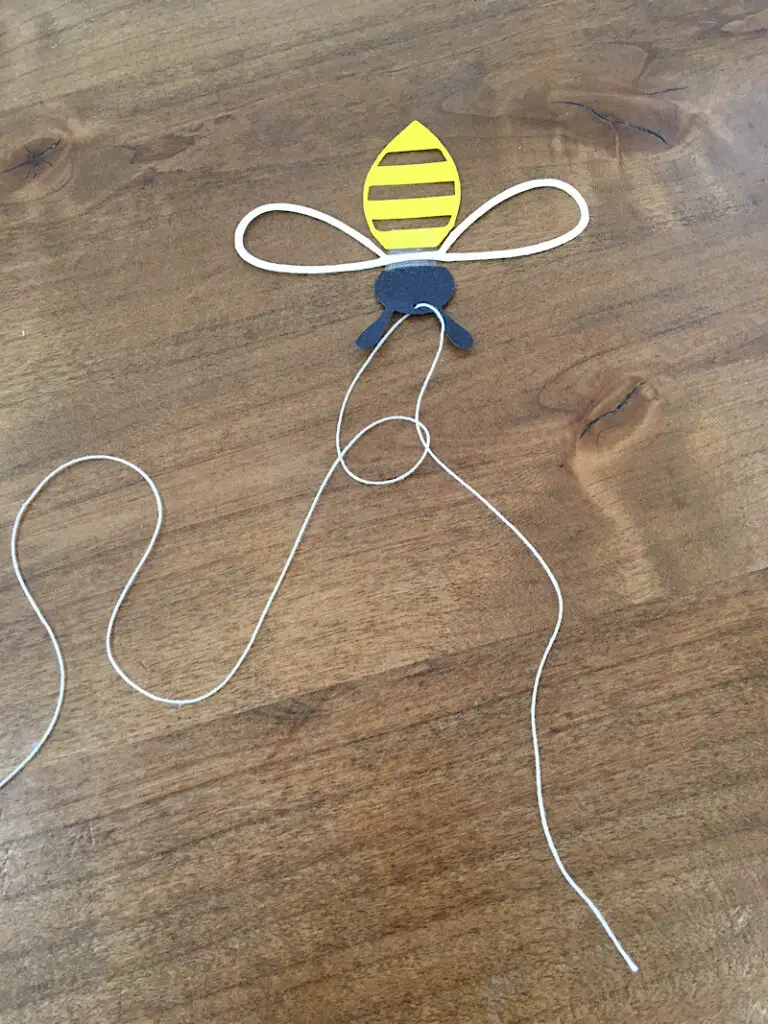 Tying the string onto the bee