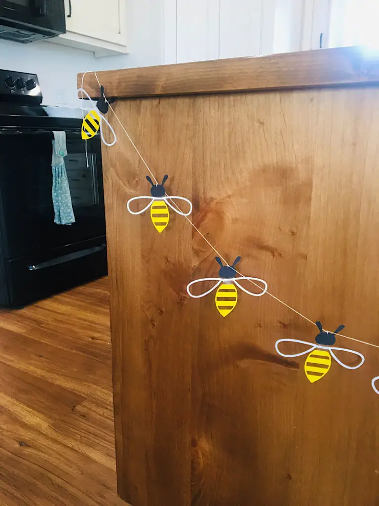 honey bee garland on wood cabinet