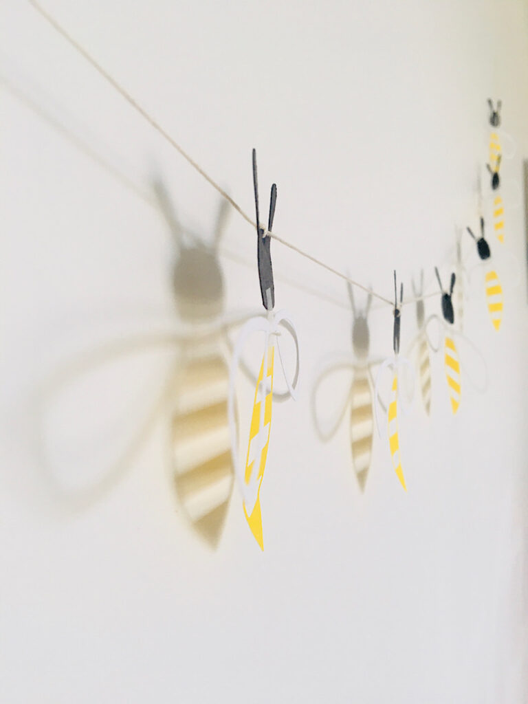 honey bee garland shadows on wall